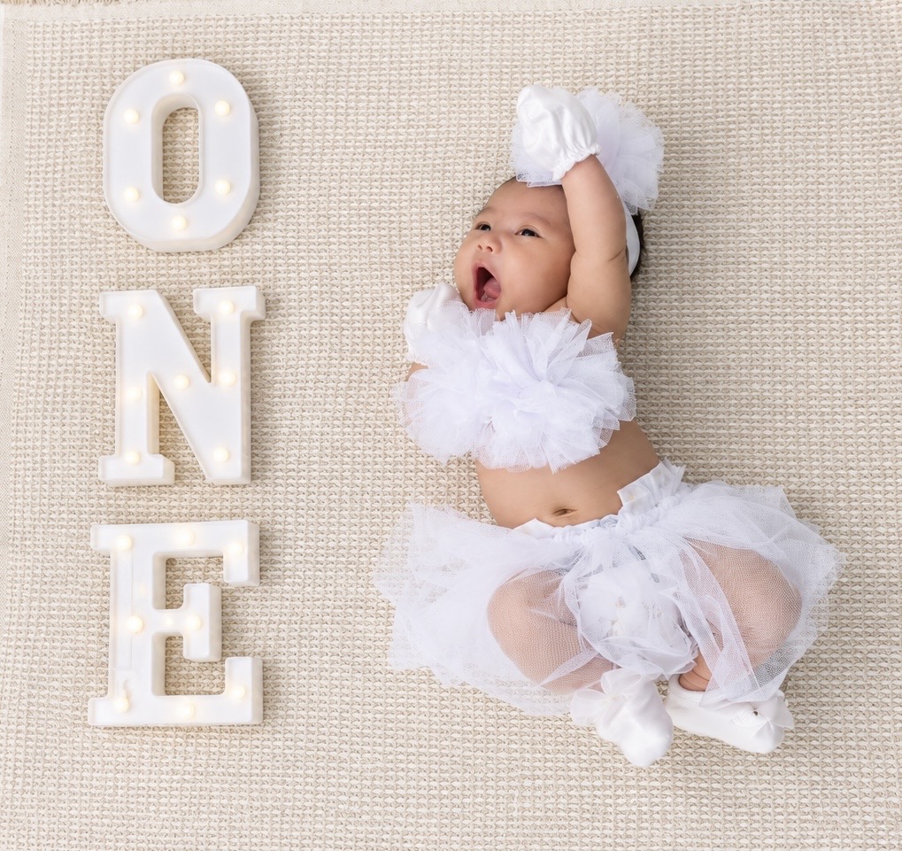 Dorothea Maeve in white beside the word ONE